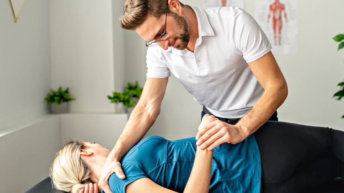 Physiotherapist helping patient