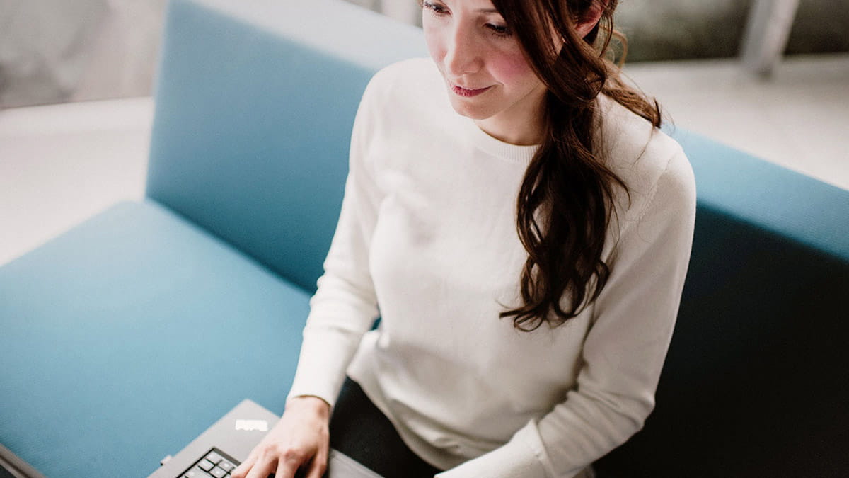 Woman on laptop researching best health cover and excess options