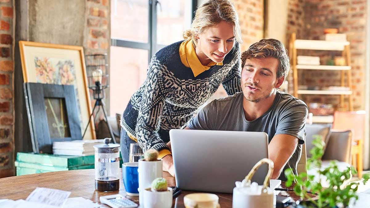 Young couple researching health insurance, tax and LHC