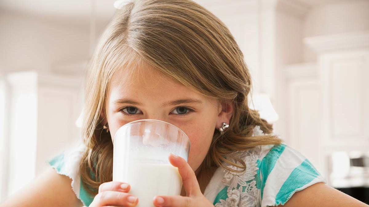 Girl drinking a glass of milk