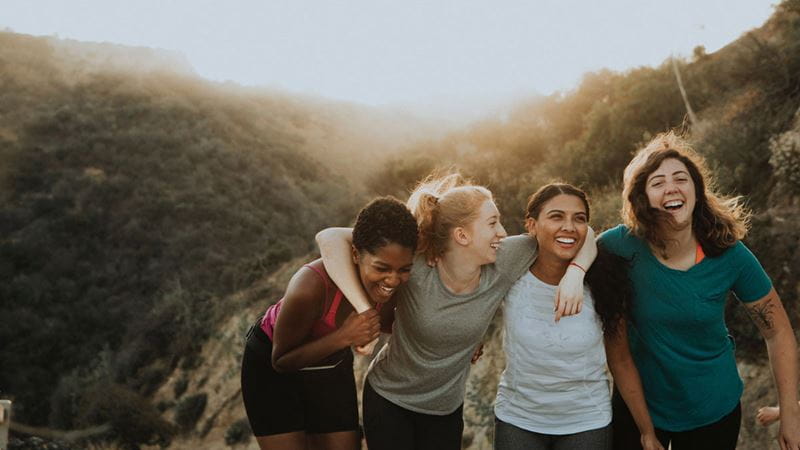 Group of young girls laughing at sunset