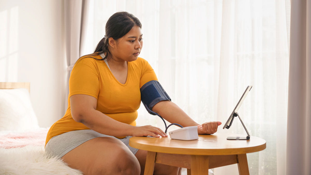 Woman measuring her blood pressure