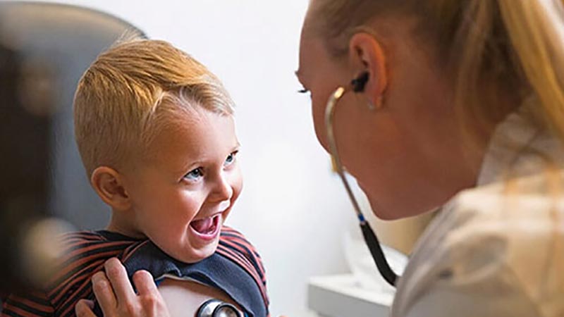Young boy having his chest listened to by doctor
