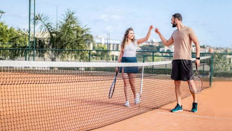 Couple playing tennis