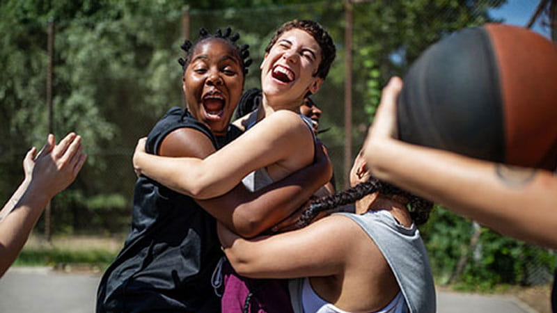 Basketball team hugging