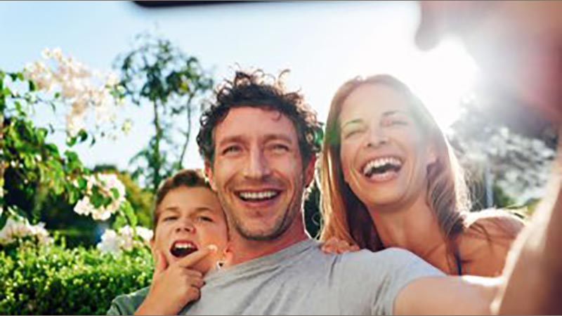 Parents doing a selfie with young child