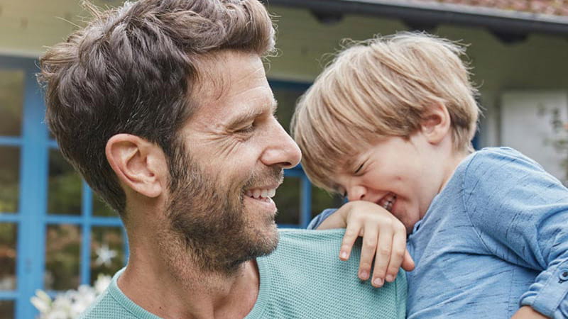 Father and young boy laughing