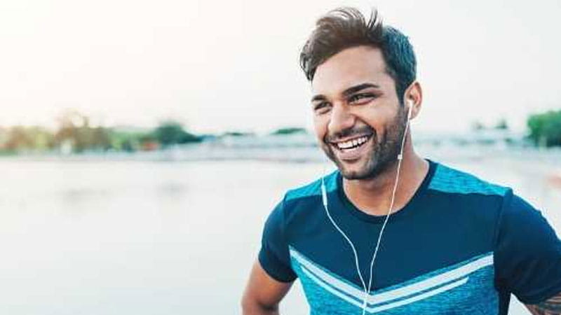 Man after beach run smiling