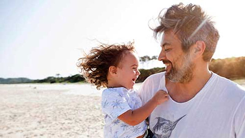 Man with child at beach