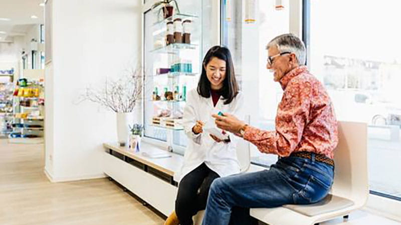 Older man talking to pharmacist
