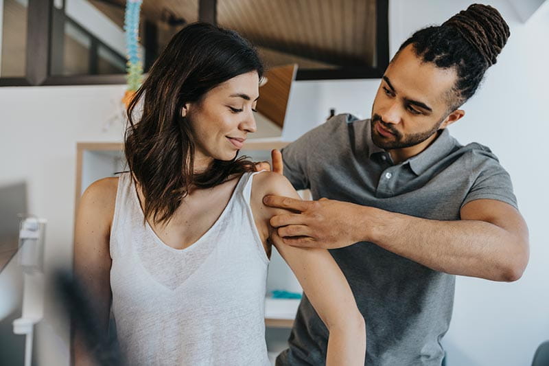 Physio treating woman's shoulder