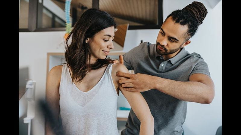 Physio treating woman's shoulder