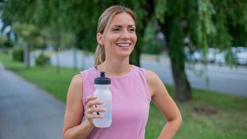 Woman running with a water bottle