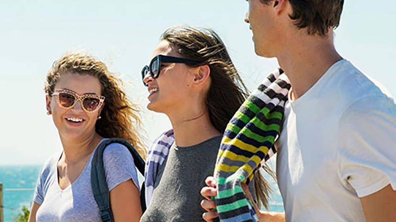Young smiling adults at the beach