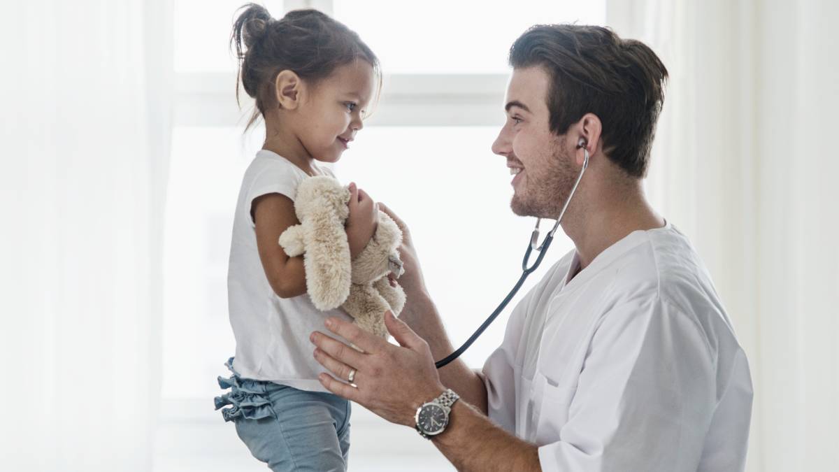 Doctor giving a young girl a checkup