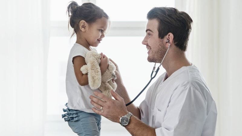 Doctor giving a young girl a checkup