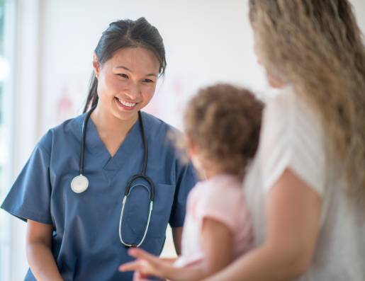 Female doctor attending to mother and her child