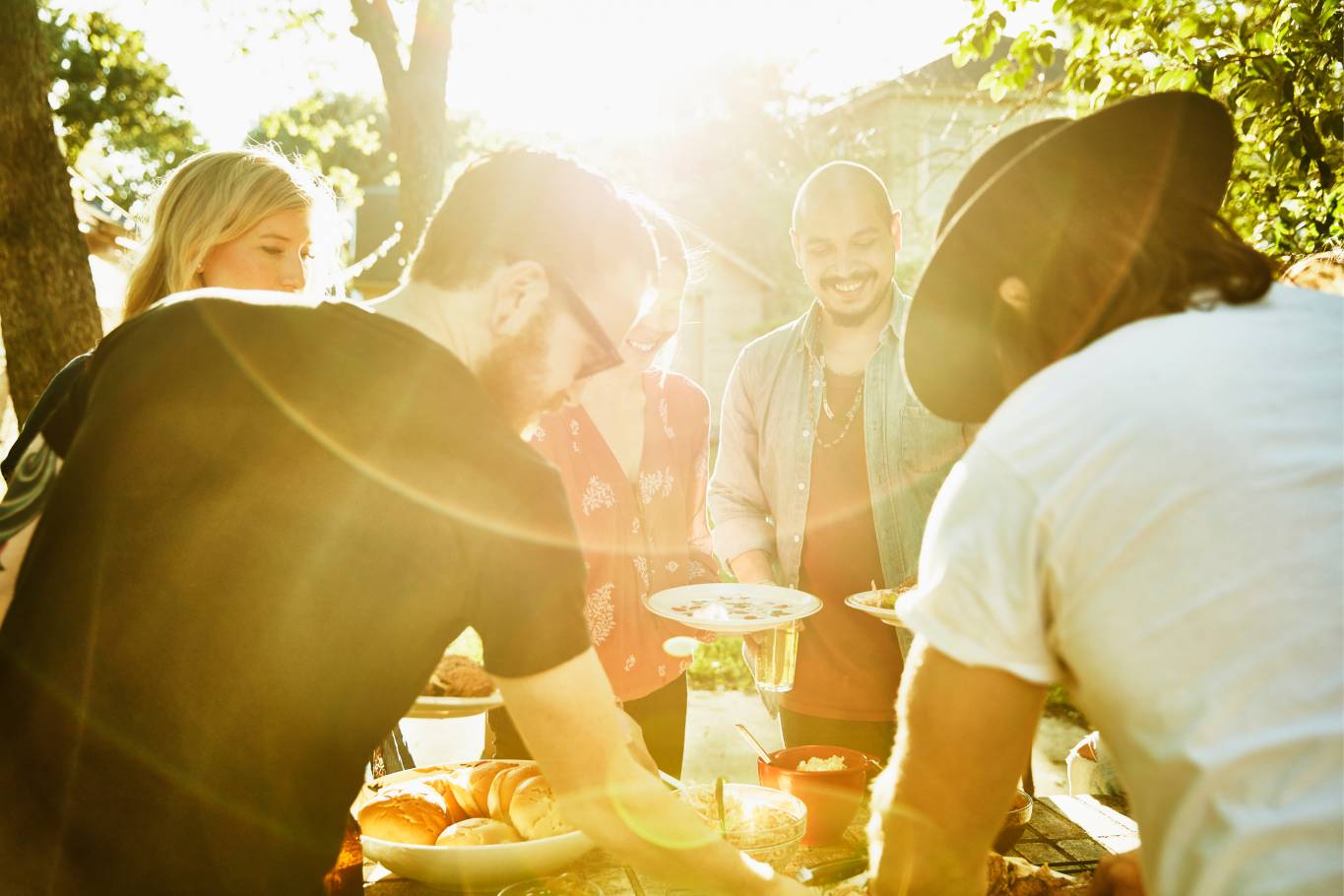 Friends enjoying lunch outdoors in the sun