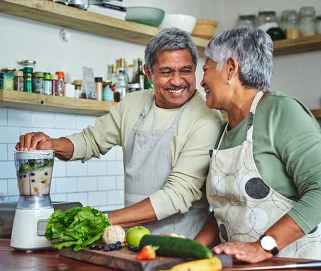 Couple in the kitchen with a blender