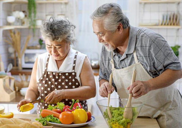 Elderly couple cooking