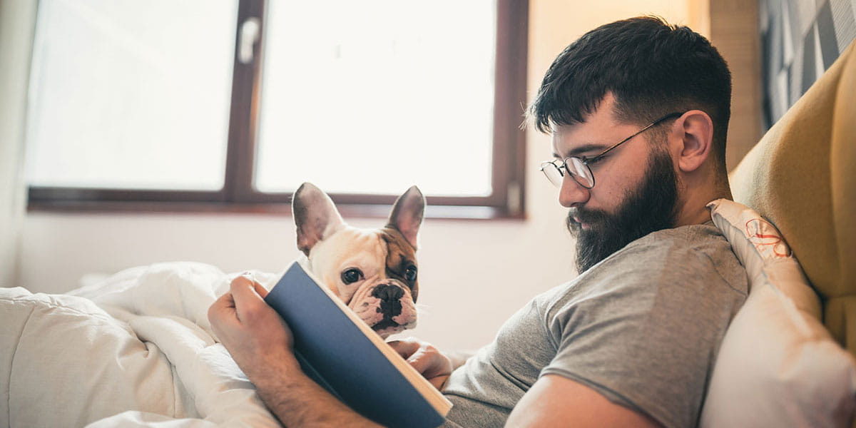 Man reading with dog