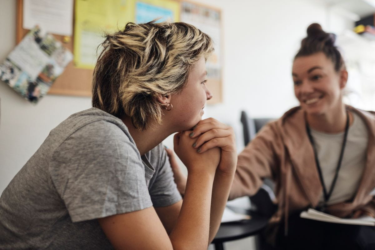 Two young women talking and smiling
