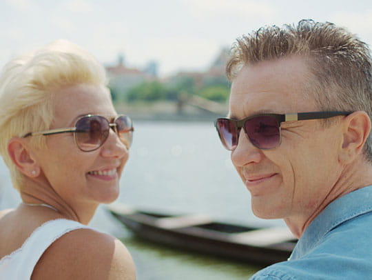 Elderly couple with sunglasses on smiling