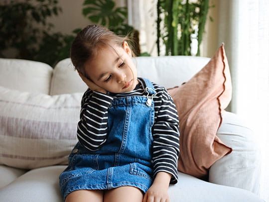 Little girl holding ear