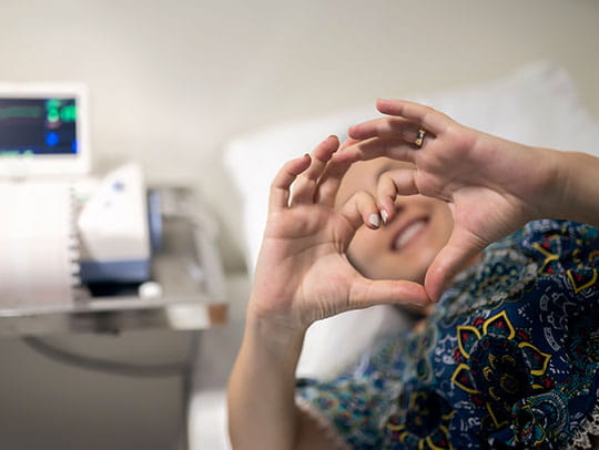 Woman making a heart symbol with her hands