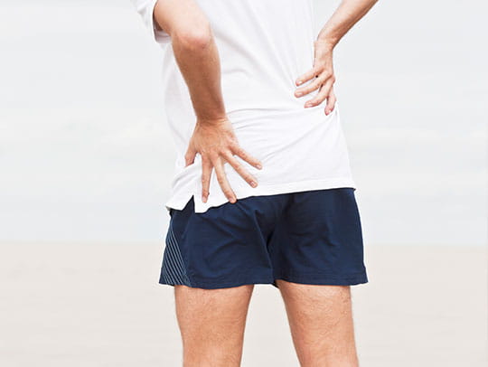 Man holding hips