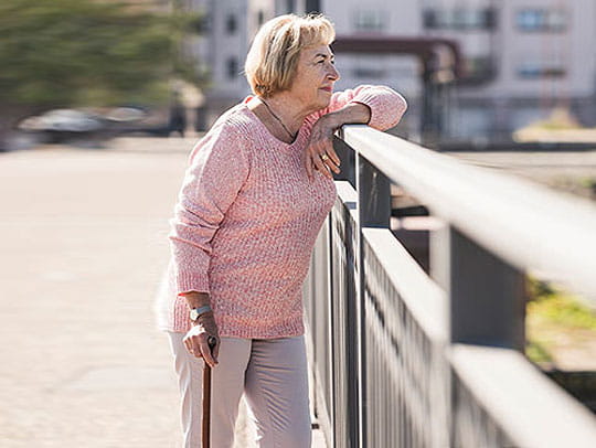 Older woman looking on bridge