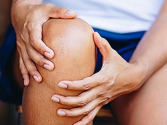 Person holding knee