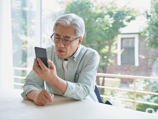 Older man looking at phone