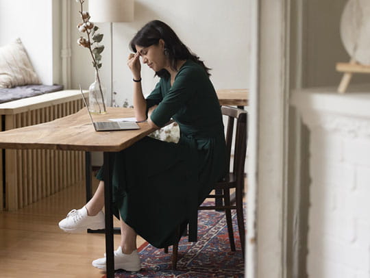 Worried woman sitting at desk