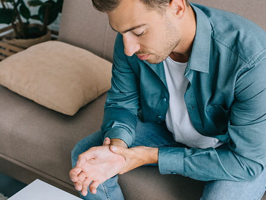 Man holding his wrist