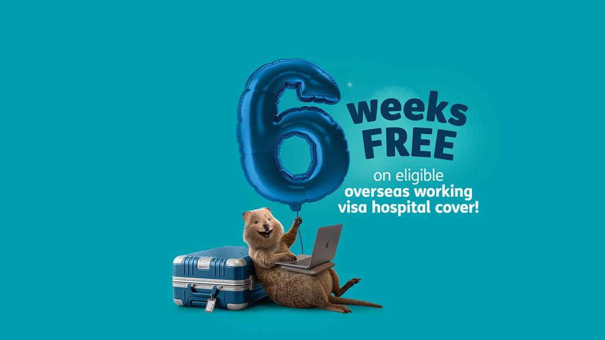 Quokka mascot sitting with a laptop and suitcase, holding a large number 6 balloon beside text promoting 6 weeks free on eligible overseas working visa hospital cover.