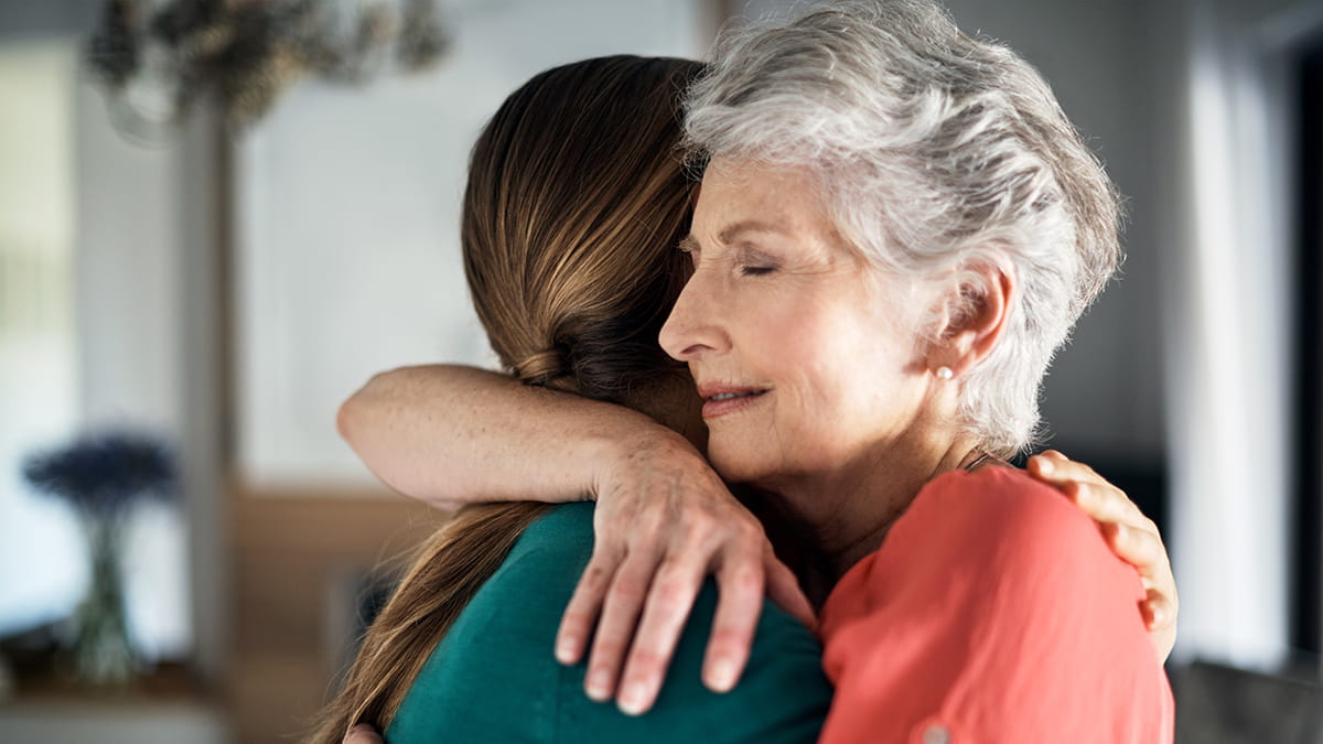 Mother hugging daughter