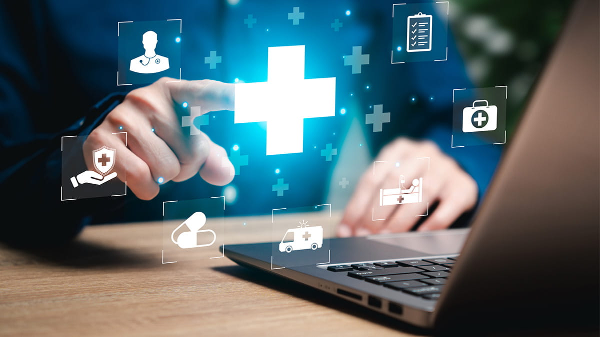 Male hands pointing at 3D graphics as they jump out from laptop screen