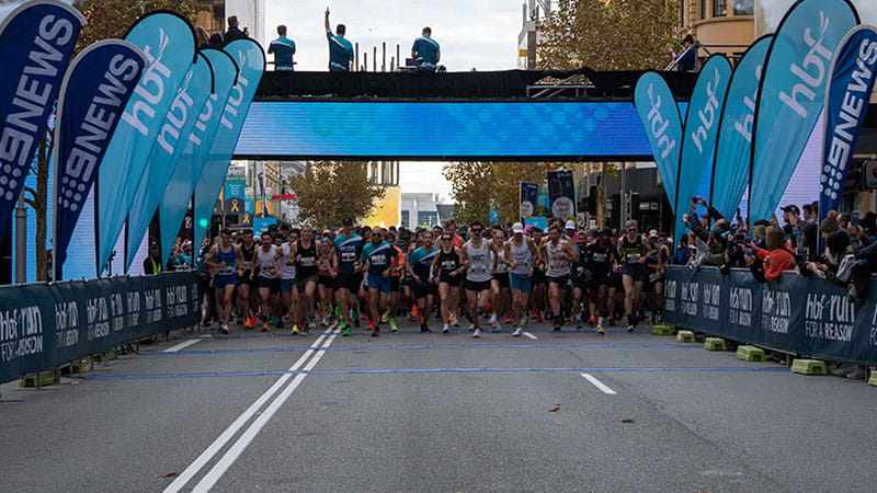 People crossing finish line in race