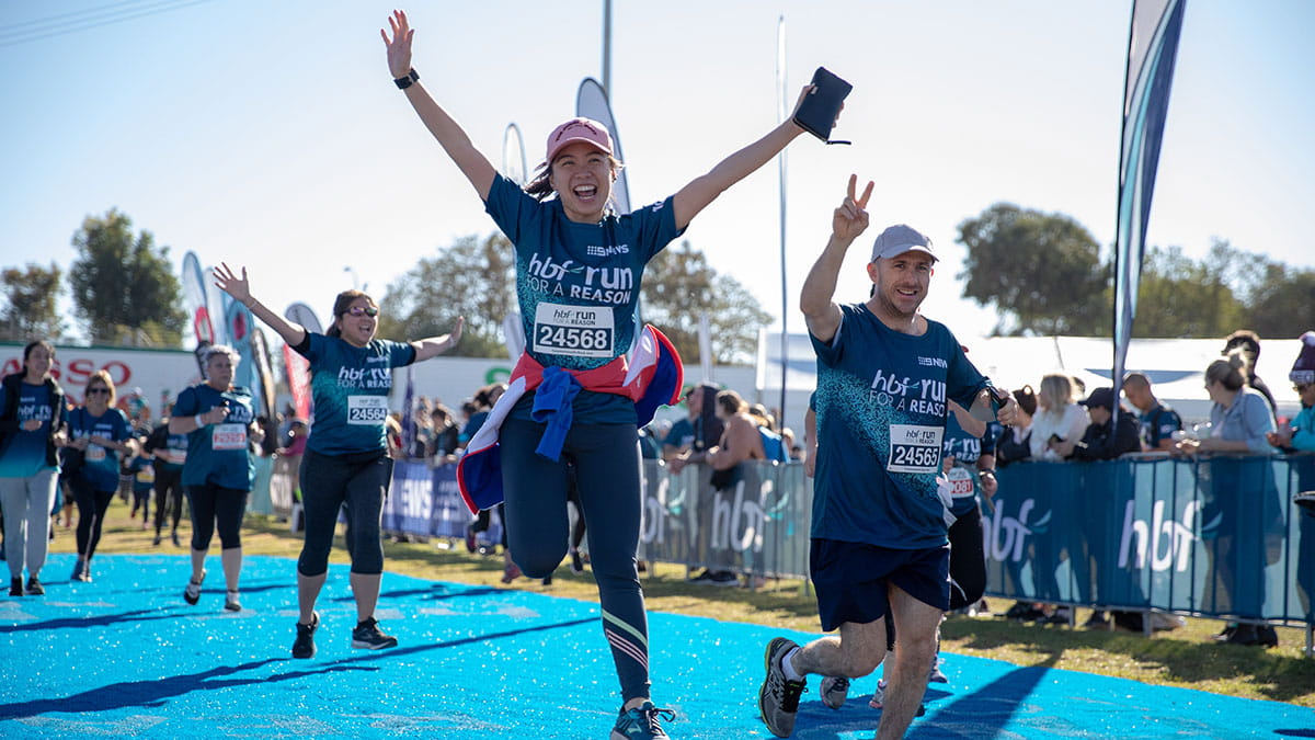 Woman crossing HBF Run For A Reason finish line
