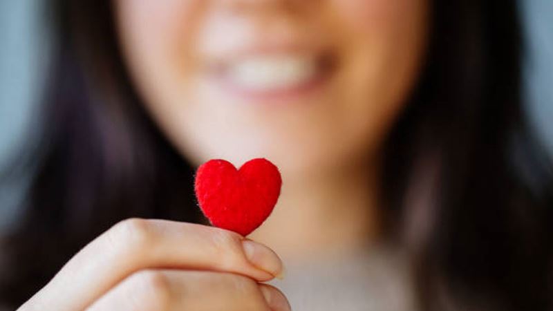 Woman holding paper heart