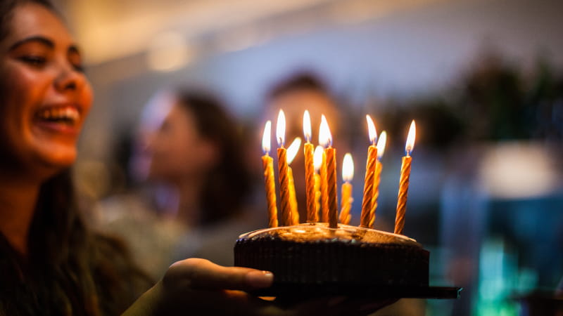 Woman blowing out candles