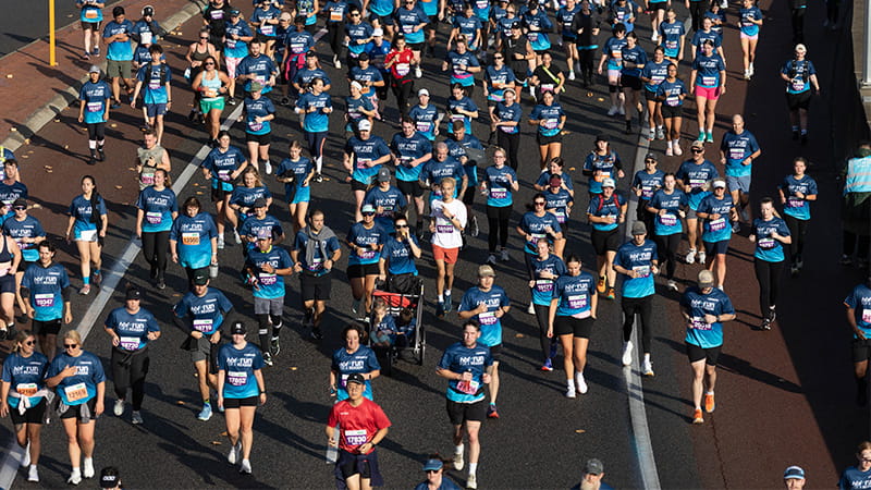 Large crowd running down a closed road