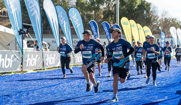 Two boys approaching HBF Run for a Reason finish line