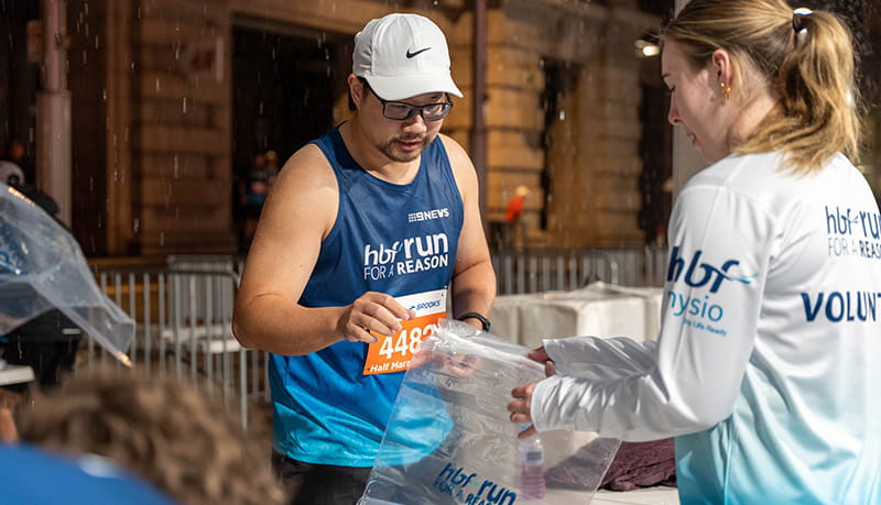 Participant dropping off belongings at bag drop