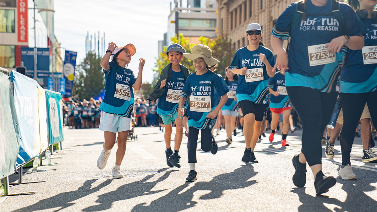 Three smiling children participating in HBF Run for a Reason