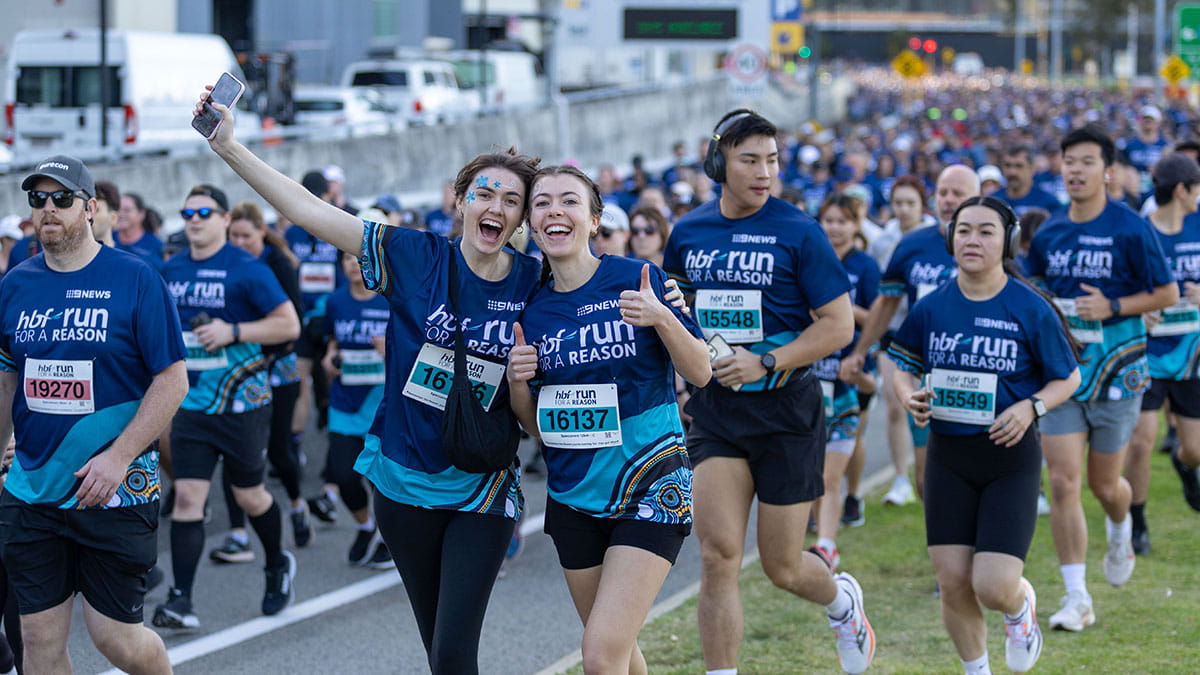 Two Run for a Reason participants giving the thumbs up at the finish line