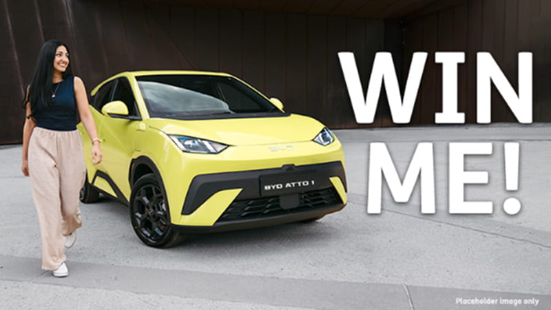 Woman standing in front of a ATTO 1 All-Electric City Car from BYD
