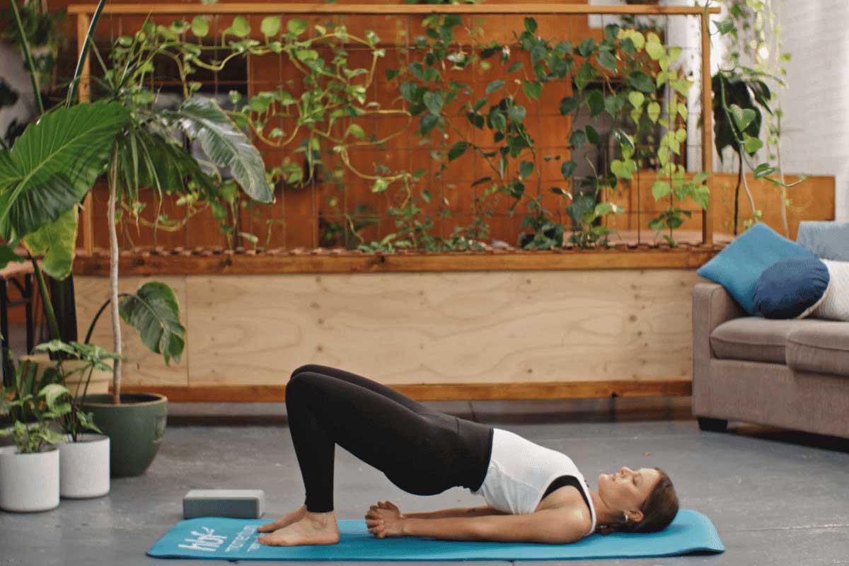 Young woman practising bridge pose in yoga