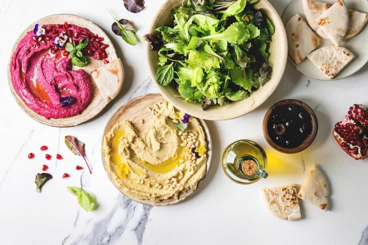 Beetroot dip and hummus dip with healthy green salad and olive oil